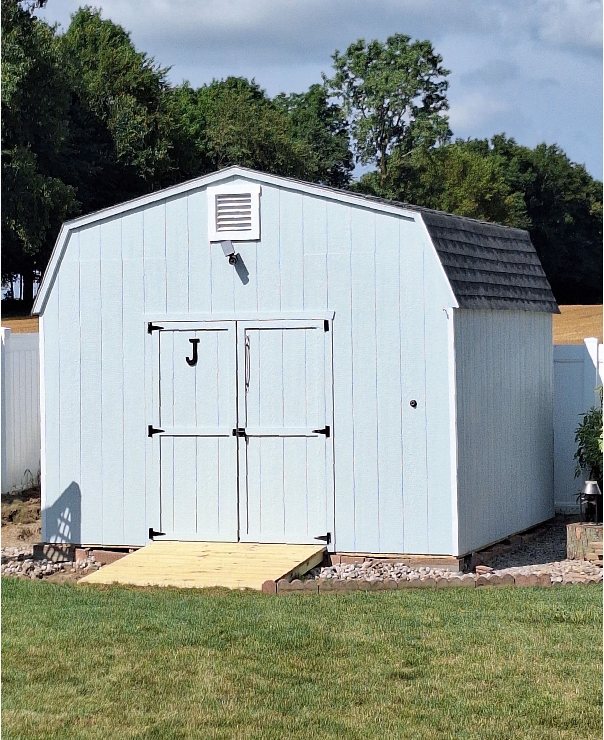 light blue shed with vents