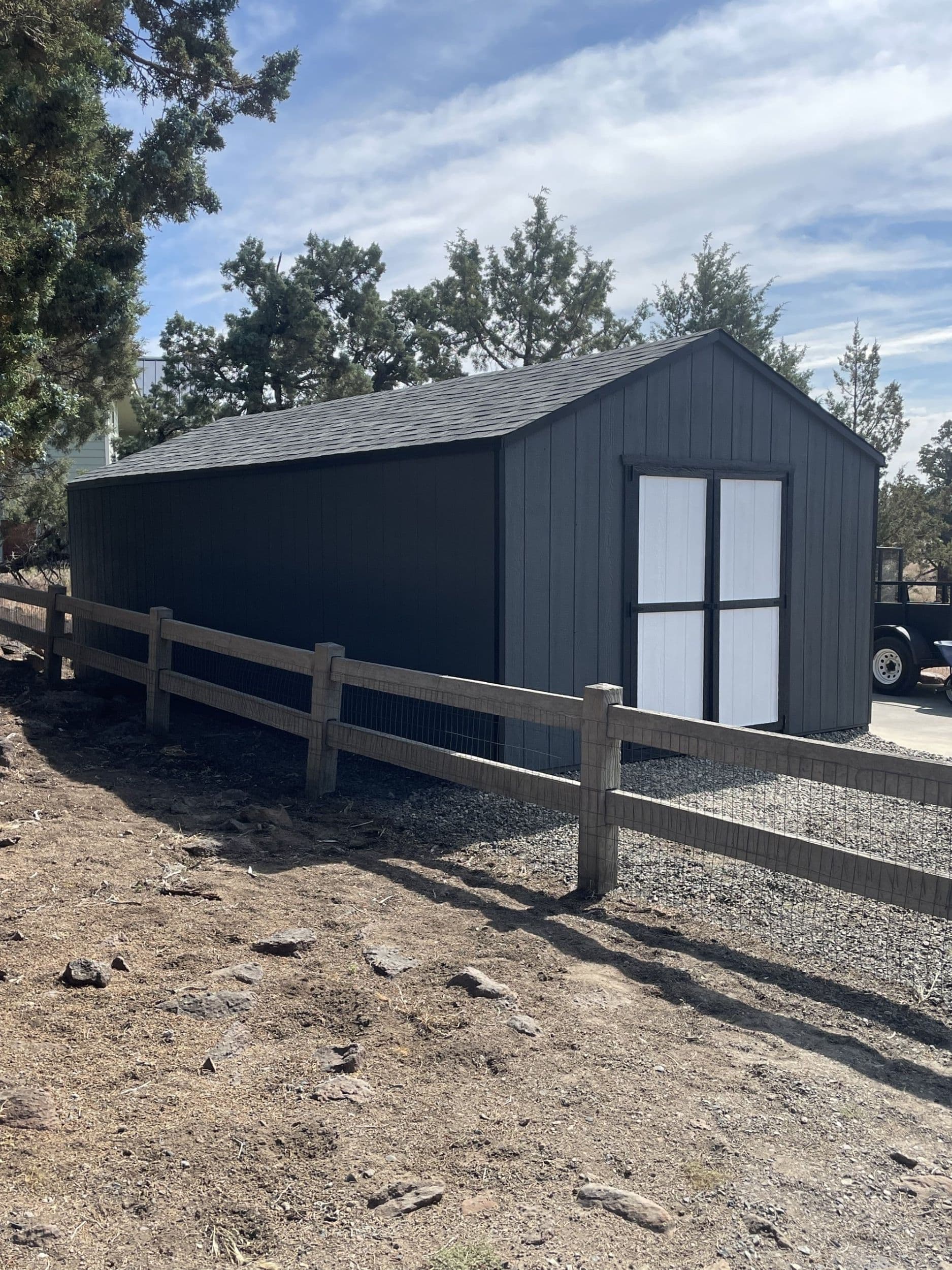 gray and white value gable wood storage shed with fence