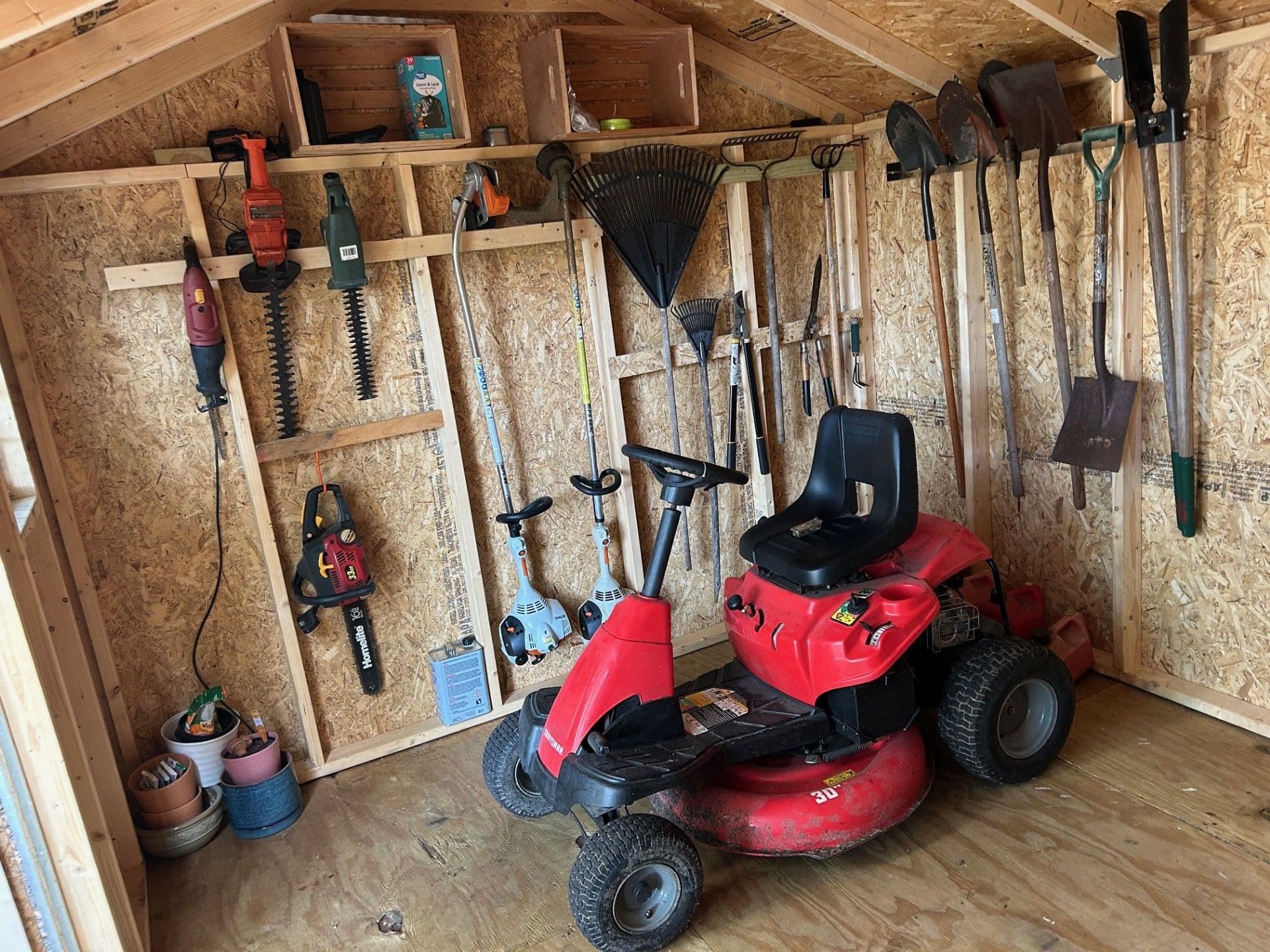 interior of value workshop storage shed with mower