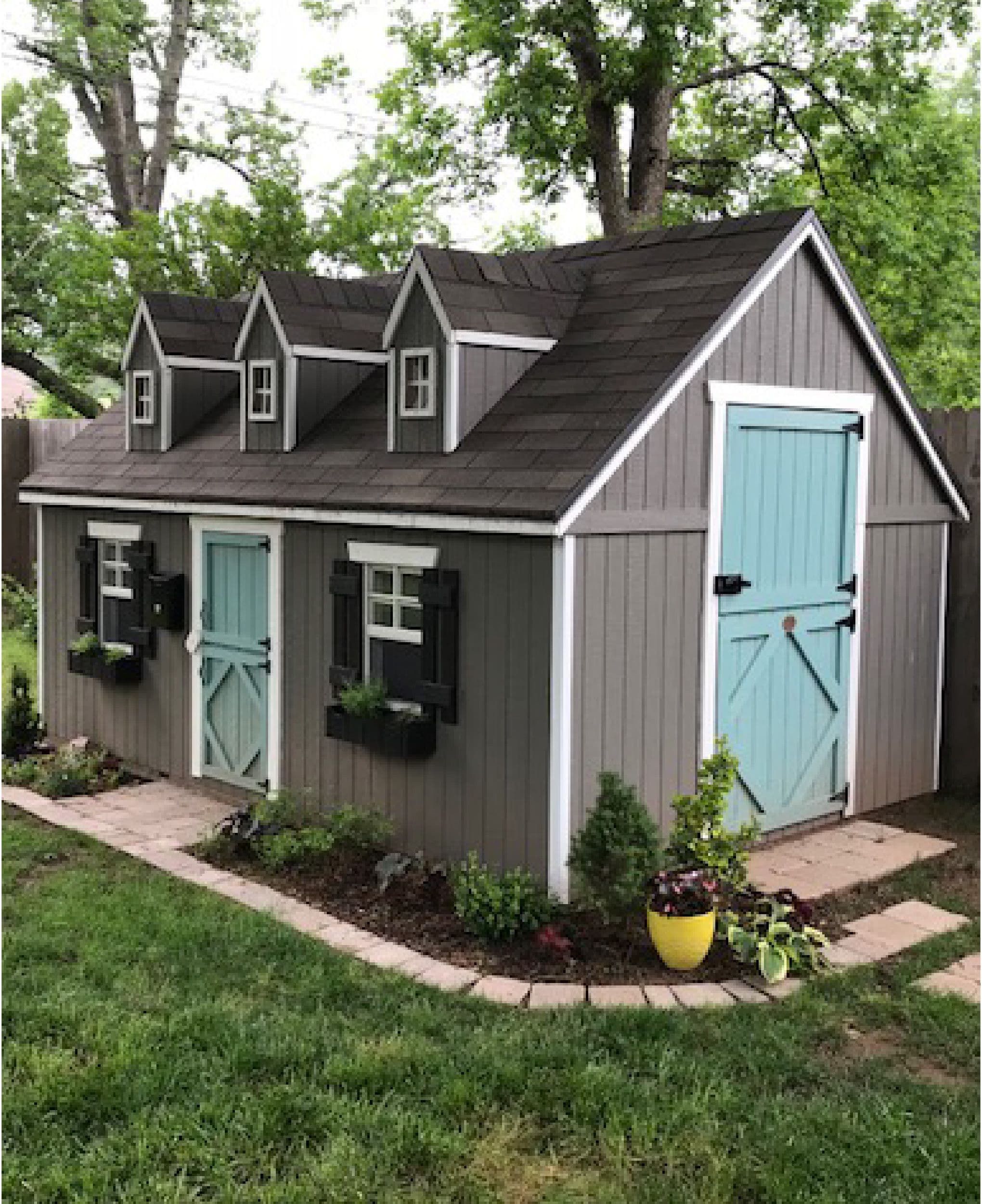 gray and blue playhouse in backyard