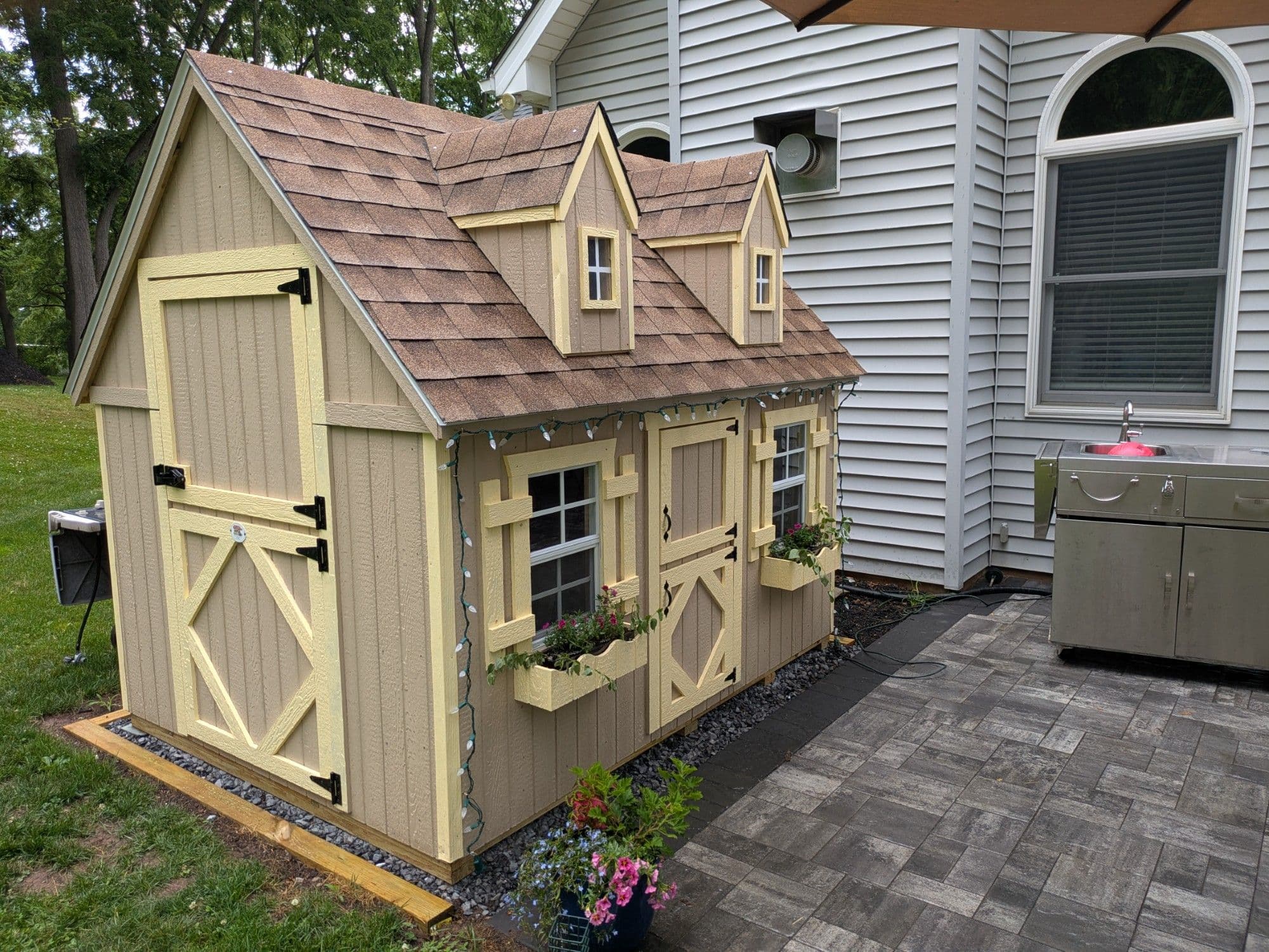 wood playhouse with lights in patio